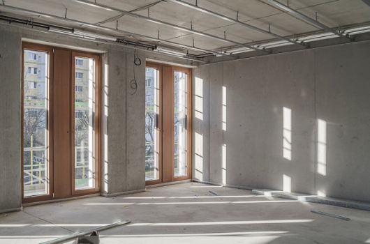 Innenansicht: Betonwände und Holz- und Alufenster